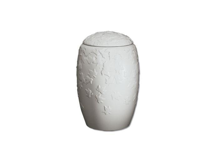 Witte urn van keramiek met herfstbladeren foto 1